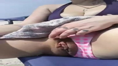 Milf gets super wet touching her hairy pussy at the public beach
